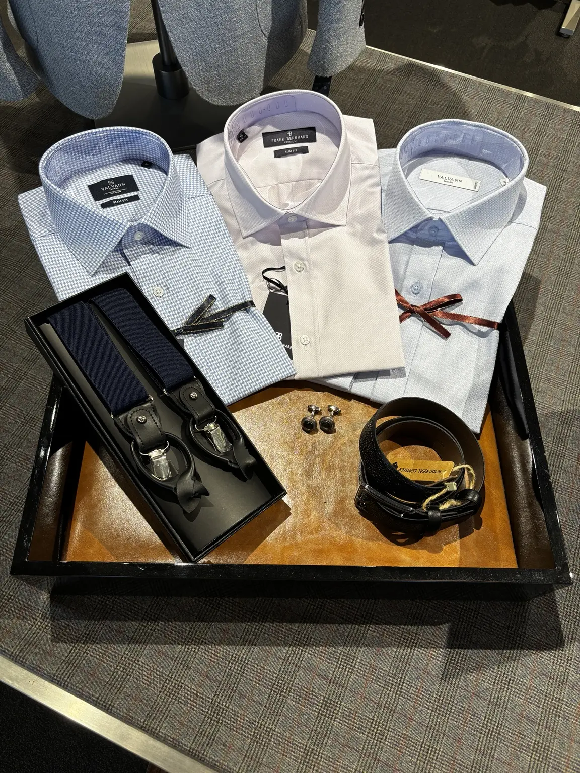 Coordinated shirts, suspenders, cufflinks, and belt displayed at Modern Suit & Dress