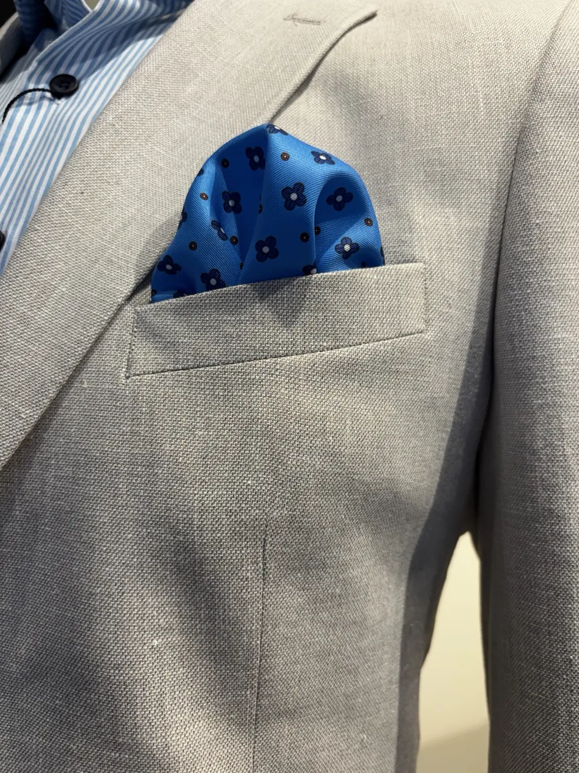 Blue floral pocket square styled with a suit at Modern Suit & Dress