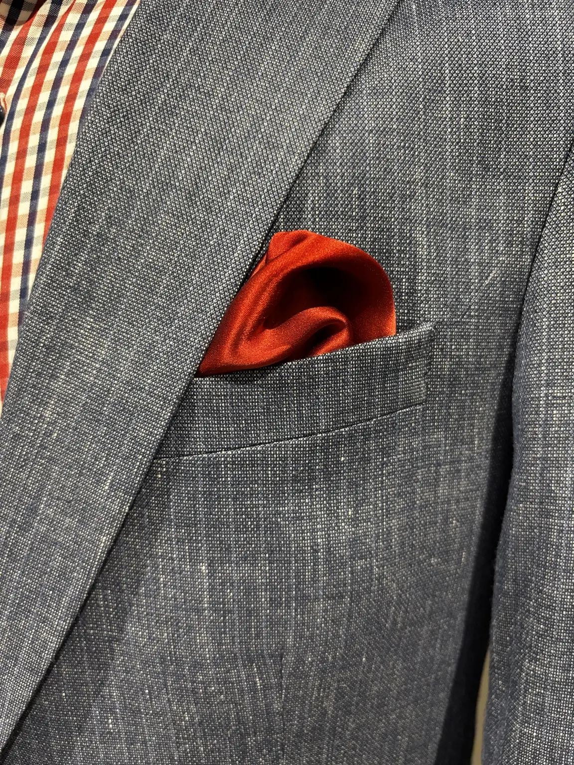 Red pocket square styled with a suit at Modern Suit & Dress