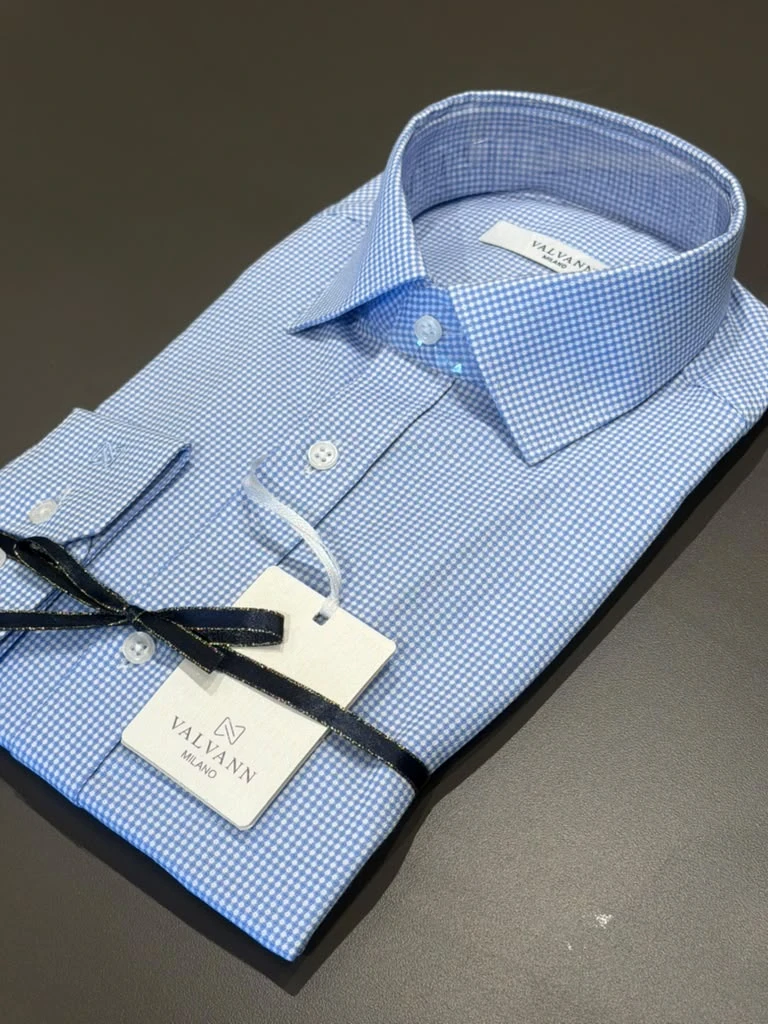 Folded blue patterned dress shirt at Modern Suit & Dress