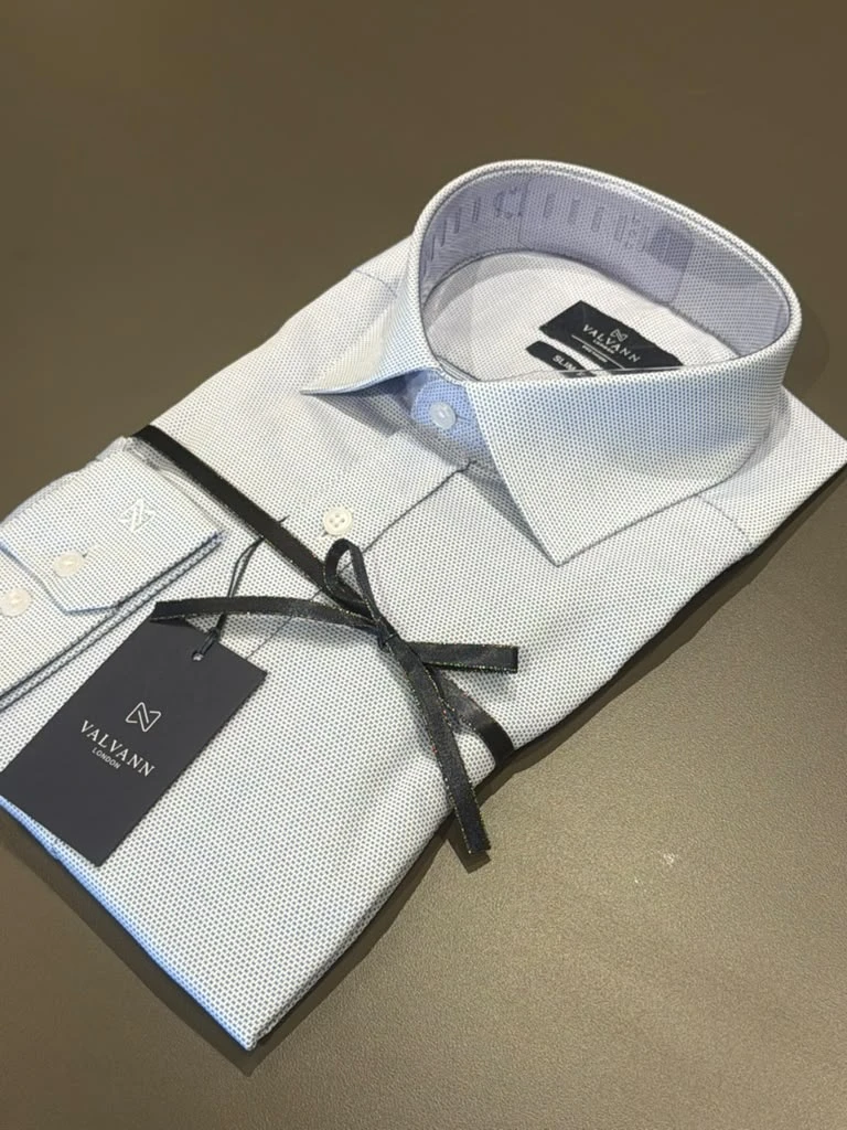 Folded white patterned dress shirt at Modern Suit & Dress