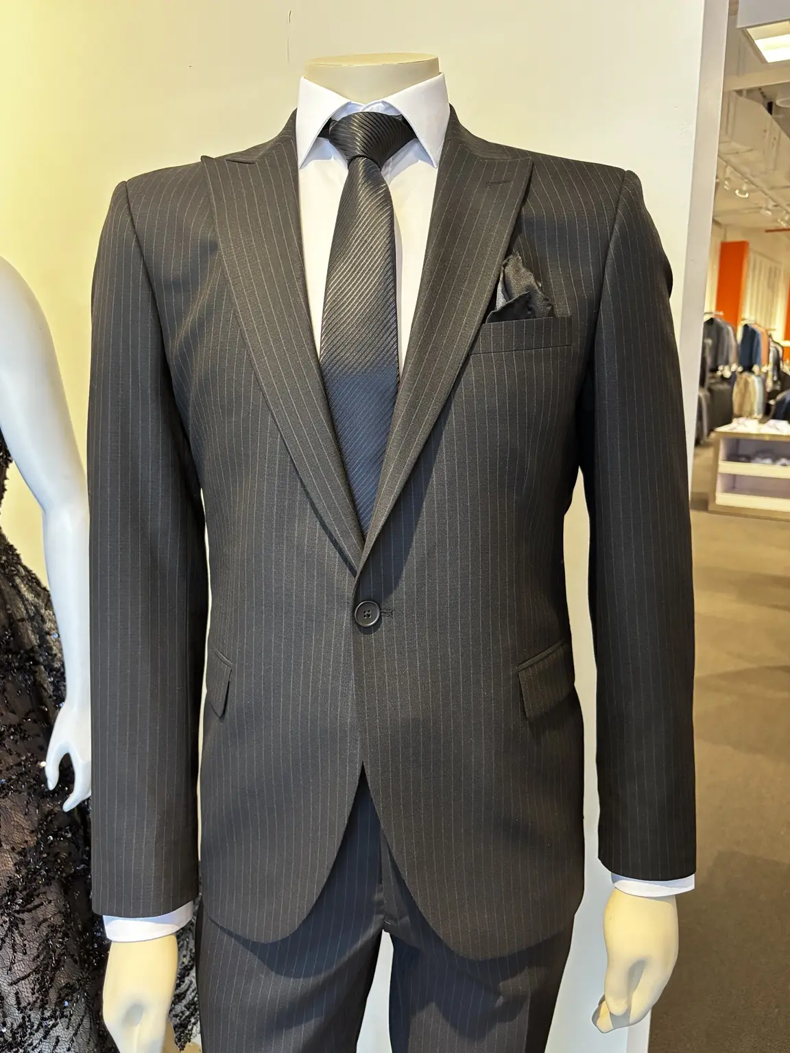 Charcoal pinstripe suit displayed on a mannequin in the Modern Suit & Dress store