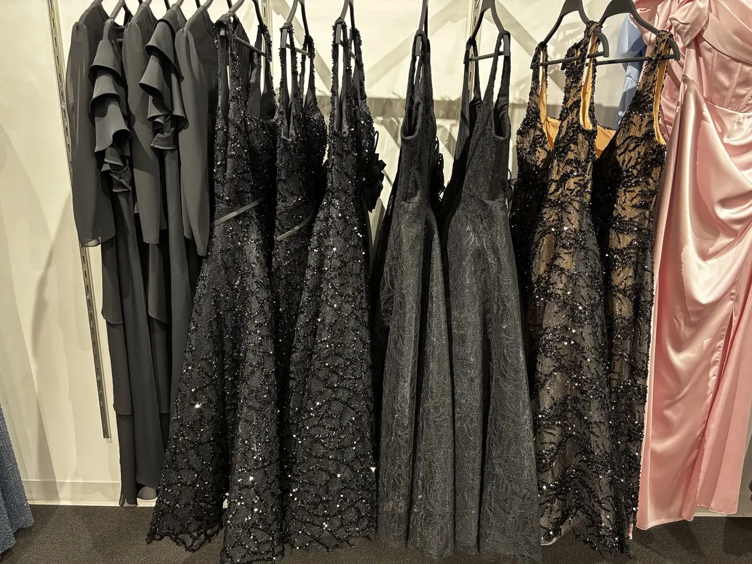 Black formal and evening dresses displayed in the Modern Suit & Dress store