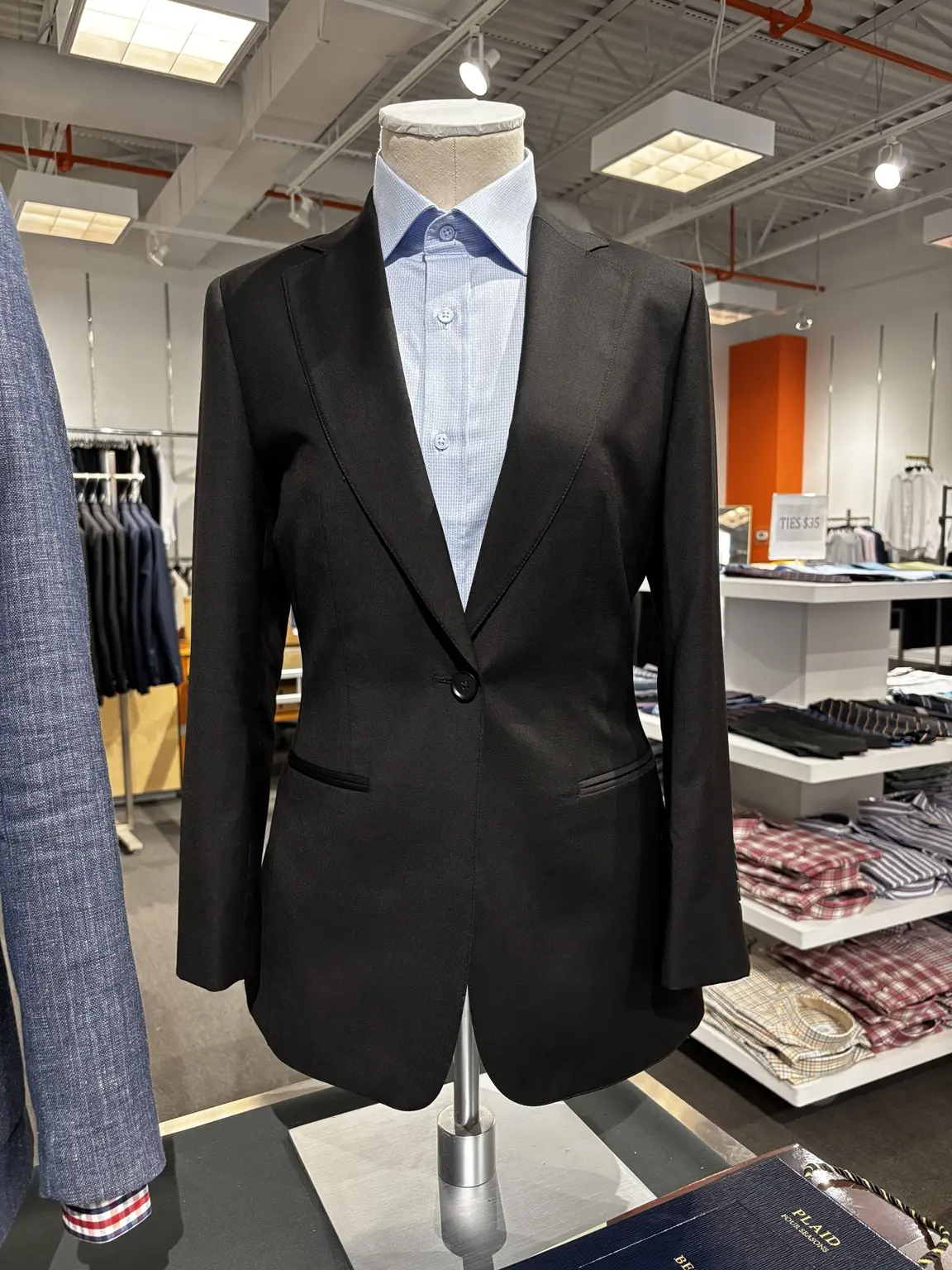 Women's black suit jacket displayed on a mannequin in the Modern Suit & Dress store