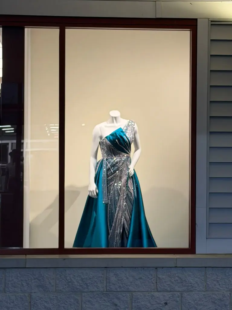 Blue and silver formal gown displayed in the store window